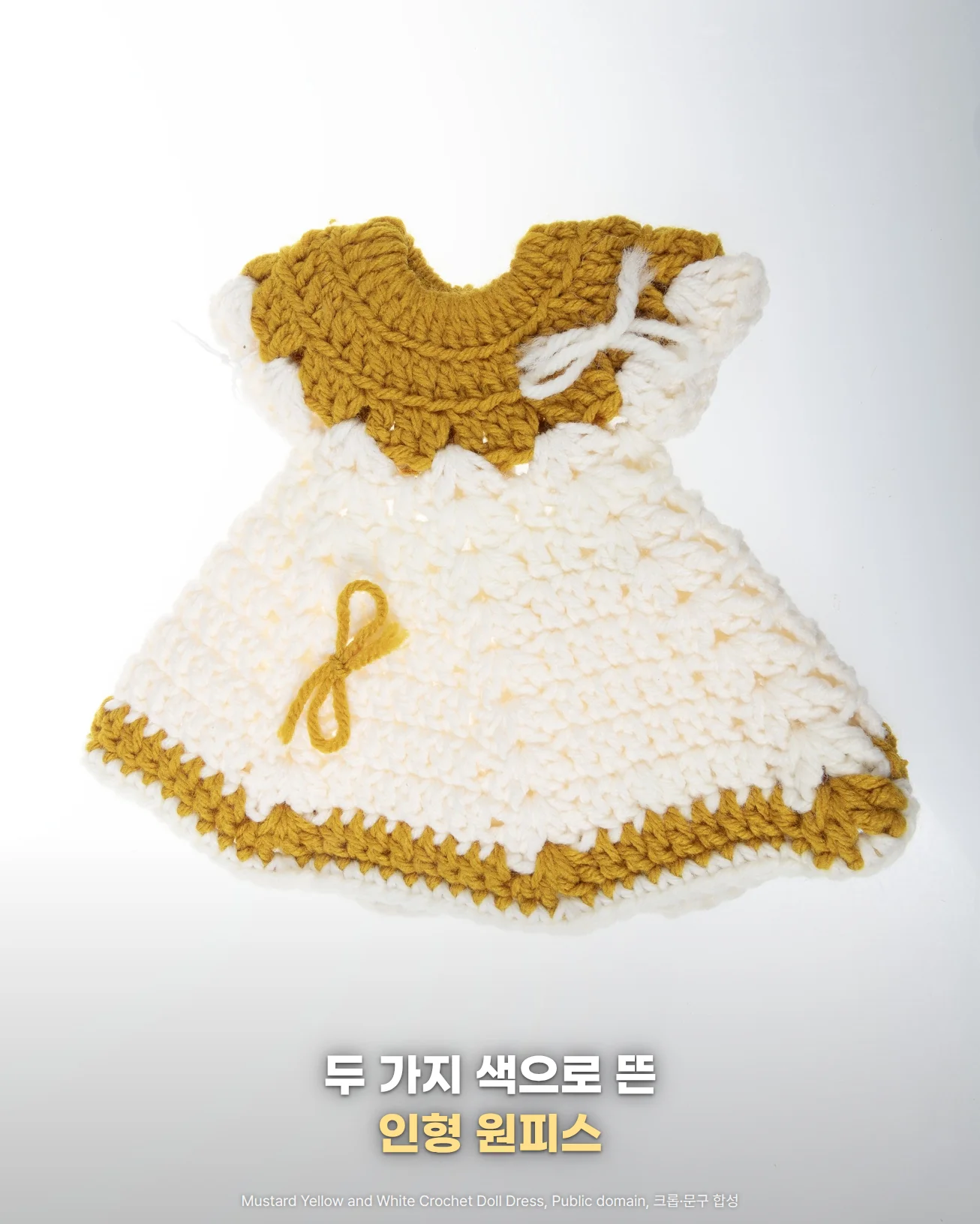 흰 바탕 위에 펼쳐 놓은 흰색 코바늘 인형 원피스 사진, 목둘레와 밑단은 겨자색이고 가슴과 치마에 리본이 달려 있으며 '두 가지 색으로 뜬', '인형 원피스' 문구가 있는 이미지
